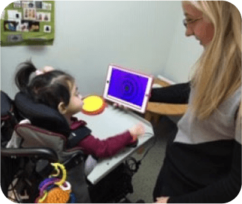A person showing the tablet to a toddler