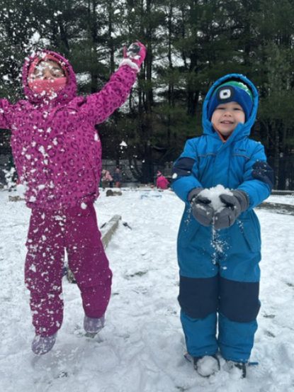 2 young children playing in the snow